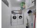 Bright laundry room with white washer and dryer, storage shelves, and white cabinets at 202 Heights Pl, Canton, GA 30114