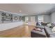 Bright living room featuring an oversized gray sofa, hardwood floors, and natural light from the windows at 202 Heights Pl, Canton, GA 30114
