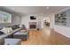 Open living room features a brick fireplace, hardwood floors, and a view of the kitchen at 202 Heights Pl, Canton, GA 30114