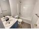 Clean bathroom with a tub, toilet and vanity with blue cabinets at 7045 Treeline Dr, Cumming, GA 30028
