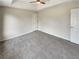 Bright bedroom with carpet, ceiling fan and double doors to closet at 7045 Treeline Dr, Cumming, GA 30028