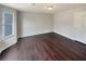 Spacious bedroom with dark hardwood floors and large window at 7045 Treeline Dr, Cumming, GA 30028