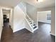 Bright entryway with dark hardwood floors and staircase leading to the upper level at 7045 Treeline Dr, Cumming, GA 30028