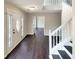 Bright entryway with dark hardwood floors and staircase at 7045 Treeline Dr, Cumming, GA 30028