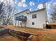 Two-story house with deck and retaining wall at 7045 Treeline Dr, Cumming, GA 30028