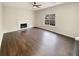 Spacious living room featuring dark hardwood floors and a fireplace at 7045 Treeline Dr, Cumming, GA 30028