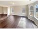 Spacious living room featuring hardwood floors and ample natural light at 7045 Treeline Dr, Cumming, GA 30028