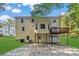 House back view, showcasing a deck and a detached garage at 1861 Shady Creek Ln, Lawrenceville, GA 30043