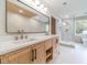 Elegant bathroom featuring double vanity and a frameless shower at 1861 Shady Creek Ln, Lawrenceville, GA 30043