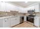 Modern kitchen with white shaker cabinets, quartz counters, and stainless steel appliances at 1861 Shady Creek Ln, Lawrenceville, GA 30043