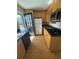 Galley kitchen with light wood cabinets and granite countertops at 4282 Roswell Ne Rd # G2, Atlanta, GA 30342