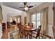 Open concept dining room with hardwood floors, shutters, and stylish ceiling fan at 600 Beckenham Walk Dr, Dacula, GA 30019