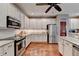 Spacious kitchen featuring stainless appliances, white cabinetry and granite countertops at 600 Beckenham Walk Dr, Dacula, GA 30019