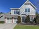 Two-story house with gray siding, brick accents, and a two-car garage at 217 Towering Peaks, Canton, GA 30114