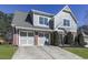 Two-story home with gray siding and brick at 217 Towering Peaks, Canton, GA 30114