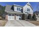 Two-story house with gray siding, brick accents, and a two-car garage at 217 Towering Peaks, Canton, GA 30114