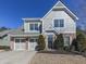 Two-story house with gray siding, brick accents, and a two-car garage at 217 Towering Peaks, Canton, GA 30114