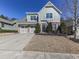 House exterior showcasing a driveway, landscaping, and neighborhood context at 217 Towering Peaks, Canton, GA 30114