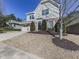 House exterior showcasing a driveway, landscaping, and neighborhood context at 217 Towering Peaks, Canton, GA 30114