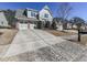 House exterior showcasing a driveway, landscaping, and neighborhood context at 217 Towering Peaks, Canton, GA 30114