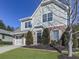 House exterior showcasing a driveway, landscaping, and neighborhood context at 217 Towering Peaks, Canton, GA 30114