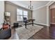 Bright home office featuring hardwood floors and a stylish chandelier at 217 Towering Peaks, Canton, GA 30114