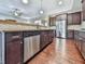 Eat-in kitchen with island, stainless steel appliances, and dark wood cabinets at 217 Towering Peaks, Canton, GA 30114