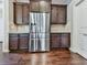 Stainless steel refrigerator in kitchen with dark wood cabinets at 217 Towering Peaks, Canton, GA 30114