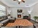 Living room with hardwood floors, fireplace, and sectional sofa at 217 Towering Peaks, Canton, GA 30114