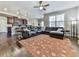 Open living room with hardwood floors, sectional sofa and kitchen view at 217 Towering Peaks, Canton, GA 30114