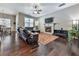 Spacious living room with hardwood floors, a fireplace, and a sectional sofa at 217 Towering Peaks, Canton, GA 30114