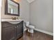 Updated powder room with dark vanity and wood floor at 217 Towering Peaks, Canton, GA 30114