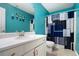 Teal bathroom with white vanity and shower/tub combo at 295 W 5 Hwy, Roopville, GA 30170