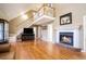 Living room featuring hardwood floors, fireplace, and loft area at 295 W 5 Hwy, Roopville, GA 30170