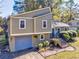 Two-story house with gray siding, a blue garage door, and a landscaped yard at 3700 Ashley Woods Dr, Powder Springs, GA 30127