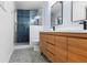 Modern bathroom with custom wood vanity, black fixtures, and stand-up shower with blue tile at 3732 Summitridge Dr, Atlanta, GA 30340