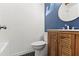 Bathroom featuring a wood cabinet, modern toilet, and stylish mirror above the sink at 3732 Summitridge Dr, Atlanta, GA 30340