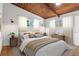 Charming bedroom featuring a wooden ceiling, neutral walls, and bright windows overlooking the trees at 3732 Summitridge Dr, Atlanta, GA 30340