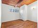 Empty bedroom featuring a wooden ceiling, neutral walls, hardwood flooring, and a bright window at 3732 Summitridge Dr, Atlanta, GA 30340