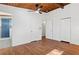 Bright bedroom with hardwood floors, white walls, and ensuite bathroom featuring blue tiled shower at 3732 Summitridge Dr, Atlanta, GA 30340