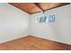 Empty bedroom featuring a wooden ceiling, neutral walls, hardwood flooring, and a bright window at 3732 Summitridge Dr, Atlanta, GA 30340