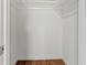 Walk-in closet featuring ample storage space and wood floor at 3732 Summitridge Dr, Atlanta, GA 30340