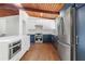 Well-lit kitchen features stainless steel appliances and two-tone cabinets underneath the wood beamed ceiling at 3732 Summitridge Dr, Atlanta, GA 30340