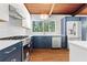 Well-lit kitchen area featuring stainless steel appliances and blue cabinets at 3732 Summitridge Dr, Atlanta, GA 30340