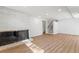 Spacious living room featuring a brick fireplace, wood floors, and staircase at 3732 Summitridge Dr, Atlanta, GA 30340