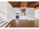 Open-concept living room with wood floors, skylight, and wood-beam ceiling at 3732 Summitridge Dr, Atlanta, GA 30340