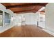 Open-concept living room featuring a striking wood-beamed ceiling and light hardwood floors at 3732 Summitridge Dr, Atlanta, GA 30340