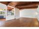 Open-concept living room with wood floors, skylight, and wood-beam ceiling at 3732 Summitridge Dr, Atlanta, GA 30340