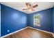 Blue bedroom with ceiling fan and laminate wood floors at 45 Ashbury Ct, Dallas, GA 30157