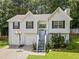 House exterior featuring a two-car garage and basketball goal at 45 Ashbury Ct, Dallas, GA 30157